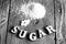 Sweetener tablet and sugar. Text sugar wooden letters.