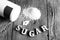 Sweetener tablet and sugar. Text sugar wooden letters.