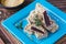 Sweetness, square beet marmalade in sesame sprinkling on a blue plate on a brown wooden background. Korean cuisine