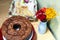 Sweets, cake, bread, juice, flowers and glass cups on a table