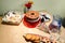 Sweets, cake, bread, juice, flowers and glass cups on a table