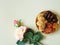 Sweets, dates, dried apricots on a plate on a beige background. Flower