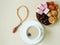 Sweets, dates, dried apricots on a plate, tea on a beige background