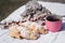 Sweets on a festive picnic. Homemade baking and hot tea in a pink glass