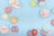 Sweets, flat lay, sweet food - macaroons, lollipops, desserts on a blue background. Banner with space for text in the middle.