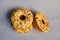 Sweets food - three yellow donuts on gray background