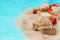 Sweets, gifts, seashells on the sand. Christmas sea travel concept