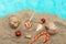 Sweets, gifts, seashells on the sand. Christmas sea travel concept