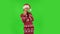Sweety girl in Santa Claus hat is coquettishly showing gesture come here. Green screen