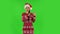 Sweety girl in Santa Claus hat is dancing funny. Green screen