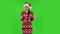 Sweety girl in Santa Claus hat is expressing she innocent. Green screen