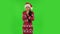 Sweety girl in Santa Claus hat froze and trying to keep warm. Green screen