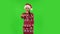 Sweety girl in Santa Claus hat is showing gesture come here. Green screen