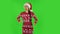 Sweety girl in Santa Claus hat is waiting and angry. Green screen