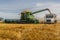Swift Current, SK, Canada- Sept 8, 2019: Combine unloading wheat into grain truck during harvest