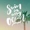 Swim in every ocean. Inspirational quote about travel at filtered background with palm tree.