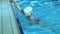 Swim finish. Slow motion of young woman swimmer practicing freestyle in swimming pool