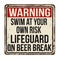 Swim at your own risk. Lifeguard on beer break vintage rusty metal sign