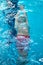 Swimmer boy swims backstroke swimming style in the pool