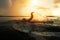 Swimmer conducts training in a lake at sunset after the rain. From under hands fly spray