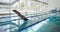 Swimmer diving into the pool at leisure center