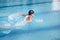 Swimmer performing the butterfly stroke,profile