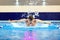 Swimmer in the pool swims butterfly inside. Athletes train wate