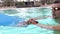 Swimmer. Professional swimmer prepares for competitions in the pool. Young athletic man wearing swimming goggles