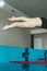 The swimmer pushes off the edge of the swimming pool. woman athlete jumps into the water indoors. Stopping in motion. View from