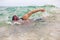 Swimmer swimming crawl freestyle in ocean wave during triathlon swim race. Man triathlete doing watersport workout