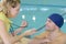 Swimmer talking to coach by poolside at leisure center