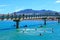 Swimmers jumping from footbridge, Raglan, New Zealand