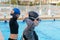 Swimmers putting on goggles before training in pool