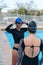 Swimmers putting on goggles before training in pool