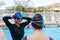 Swimmers putting on goggles before training in pool