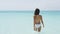 Swimming bathing beach vacation woman walking in turquoise ocean water
