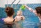 Swimming classes for little ones, infant with mother in swimming pool during training