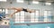 Swimming, fitness and woman dive in pool for exercise, training and workout for competition in gym. Water sports, diving