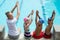 Swimming instructor with students at pool side