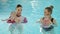 Swimming lesson. Mothers teaching to swim newborn baby at swimming pool