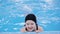 Swimming lessons for children in the pool - beautiful fair-skinned girl swims in the water