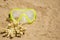 Swimming mask and a piece of yellow coral on a sandy beach. Sport and diving concept