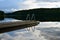 Swimming pier on calm lake with reflection