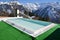 Swimming pool against snowy Alps