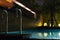 Swimming pool area at night with soft glowing outdoor lighting in expensive home in tropical southeast asia with flat water and ro