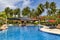 Swimming pool among a beautiful garden in Pelangi Beach Resort Spa hotel