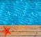 Swimming pool with blue clear water and wooden deck with star-fish