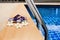 Swimming pool, blue water, white plumeria frangipani flowers, women flip flops, poolside, tropical sea beach, summer holidays