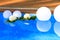 Swimming pool border decorated with white floating balls and fresh flowers for wedding party. Summer event preparation