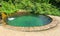 Swimming pool with clear spring cold water in the forest on a Sunny summer day.